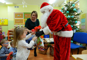 Mikołaj rozdaje prezenty dzieciom z grupy Krasnali