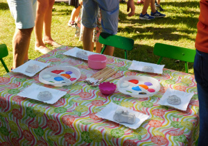 Stolik z kształtami z gipsu i farbami naszykowany do malowania przez dzieci.